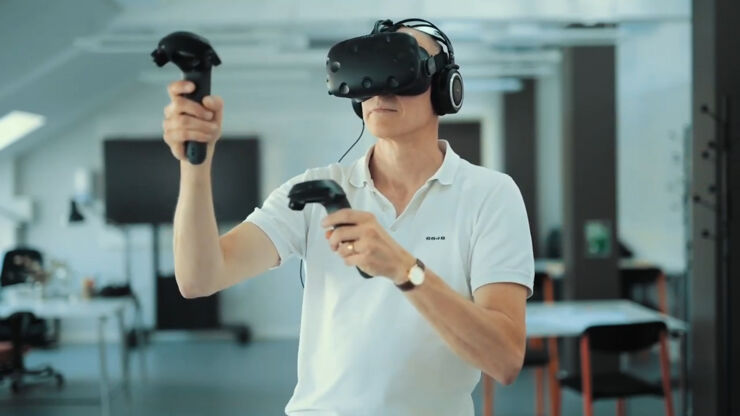 Man in white shirt wearing a VR headset