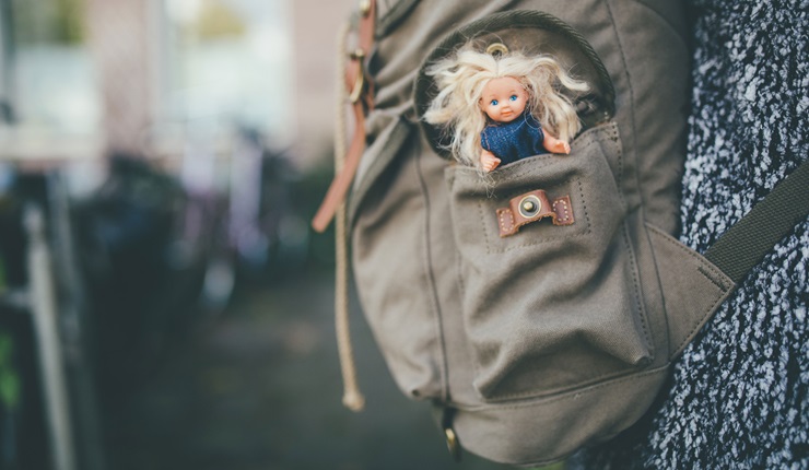 A doll in a backpack