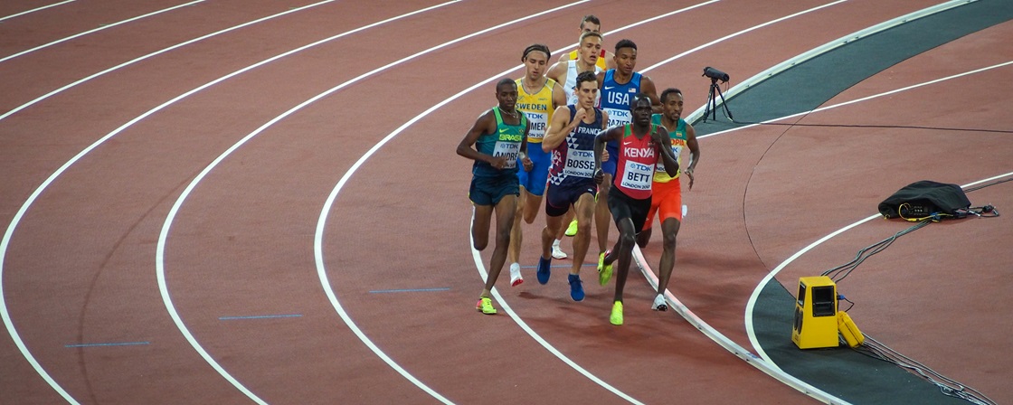 Track and field athletes running at a competition