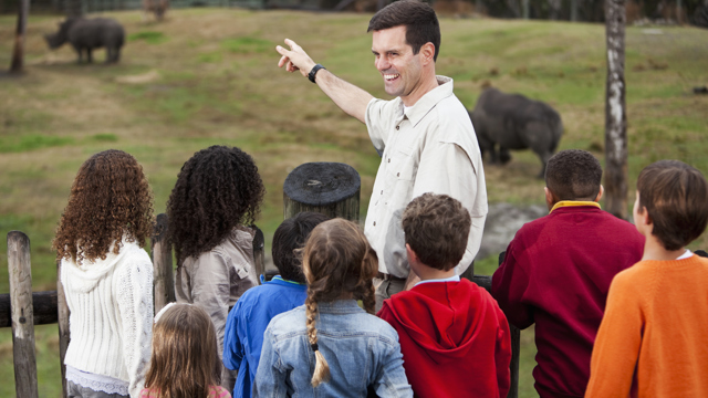 Lärare som pekar på en enhörning i en djurpark. Forskning om Utomhuspedagogik.