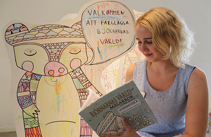 Maja Meurling med målarboken i sin monter