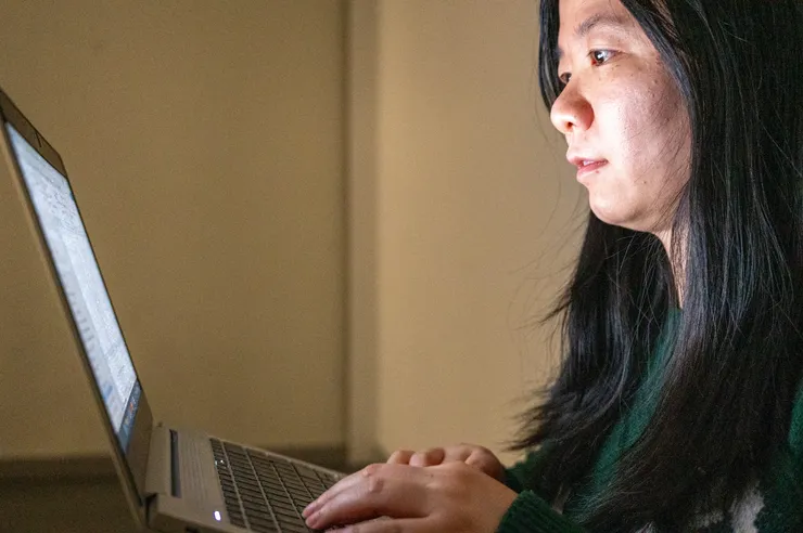 A young women looking at her computer.