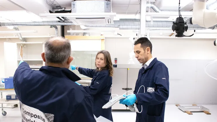 Researchers discussing in lab.