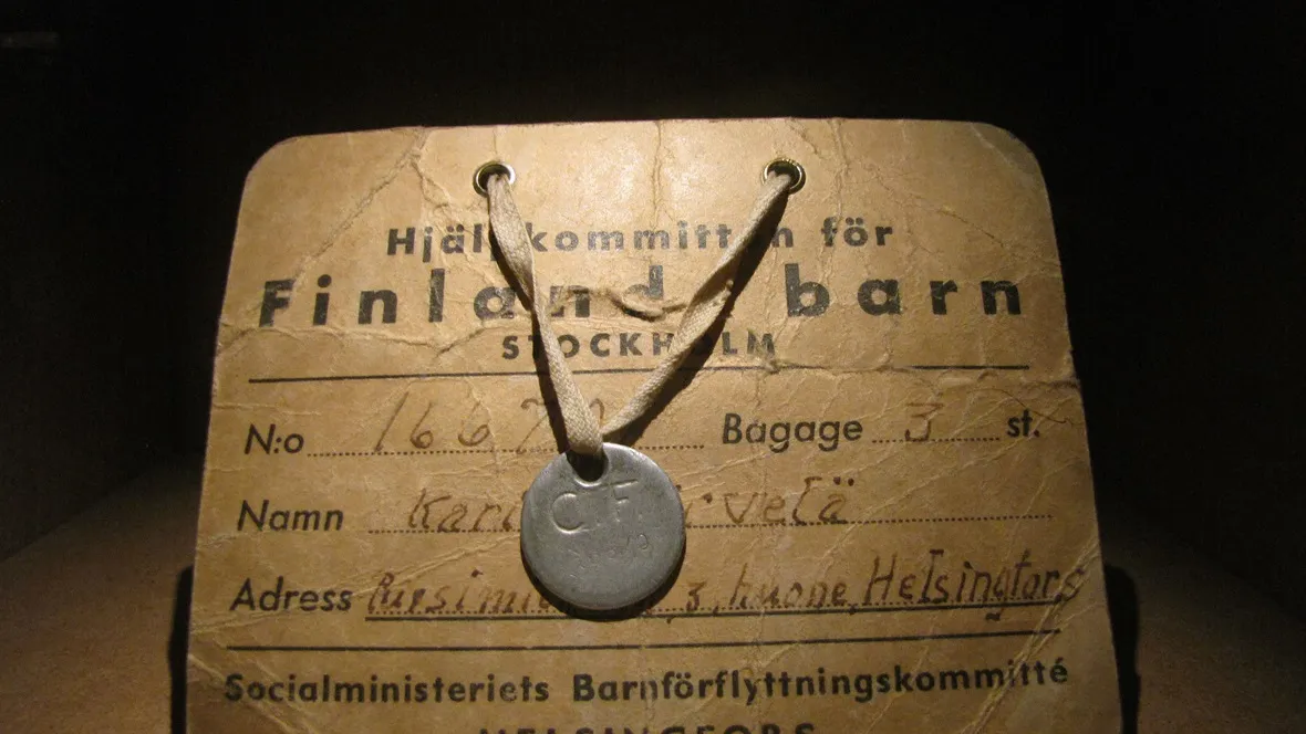 A brown label with name and other data about a person