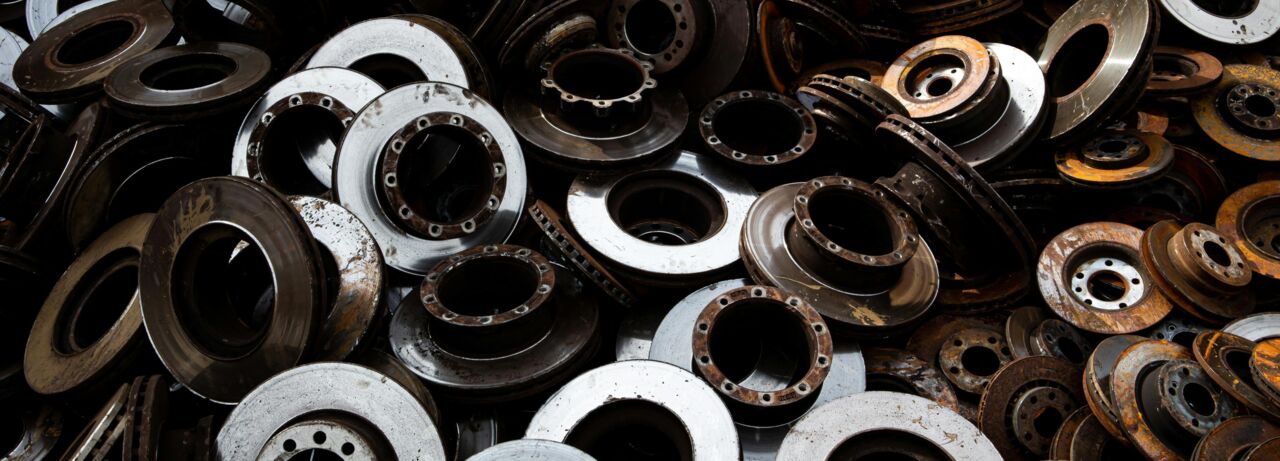 A diverse assortment of metal parts stacked together, showcasing various sizes and shapes in a disorganized manner.