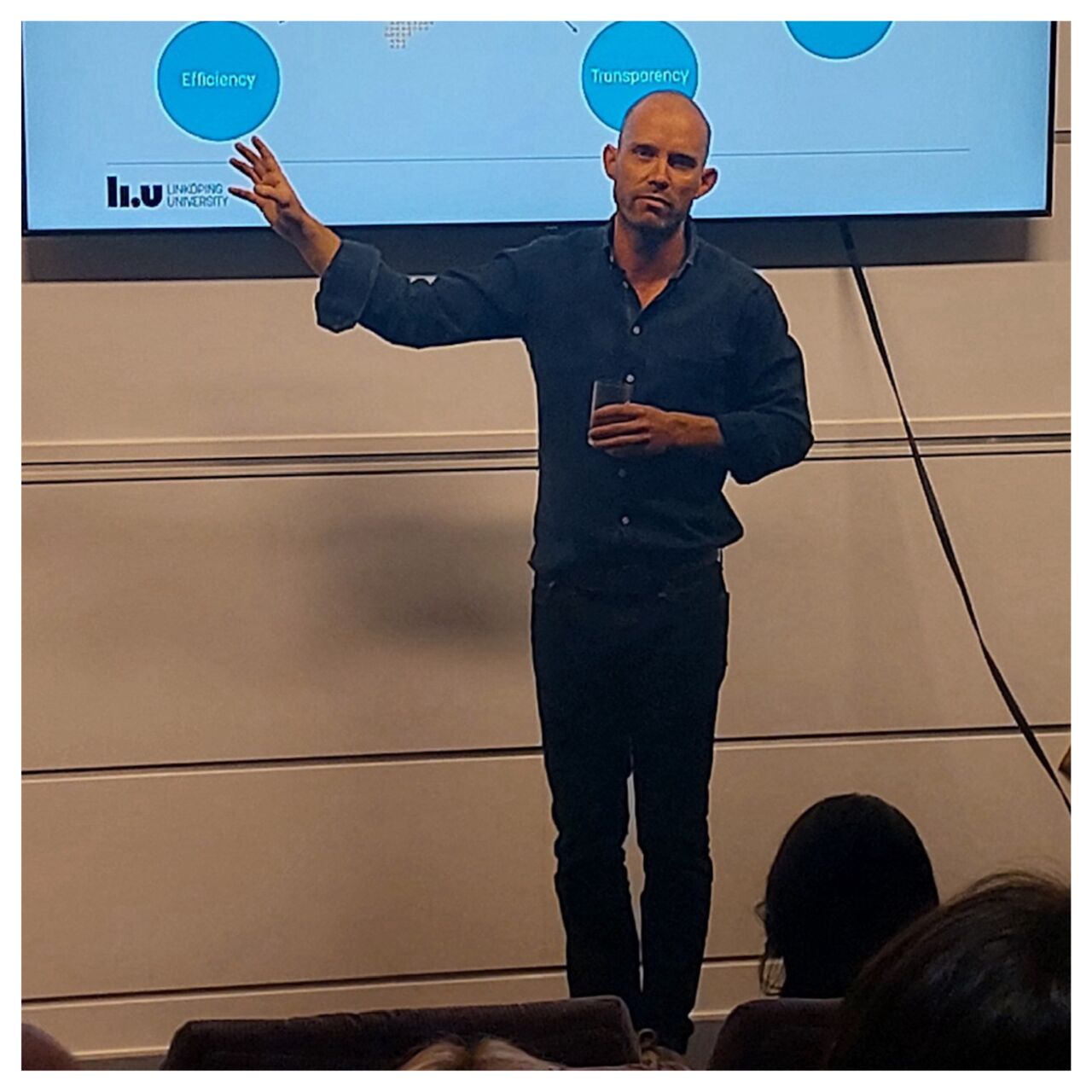 Episode guest Carl-Johan Sommar stands and lectures in front of the class.