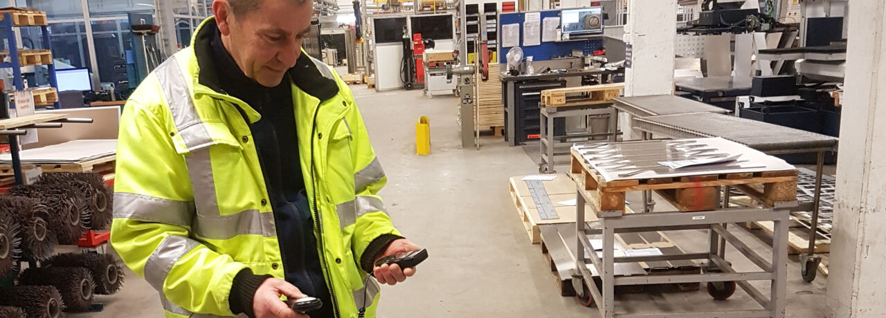 A man in the building measuring something.