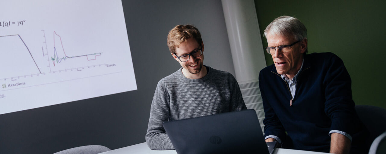 Researchers working at a computer.