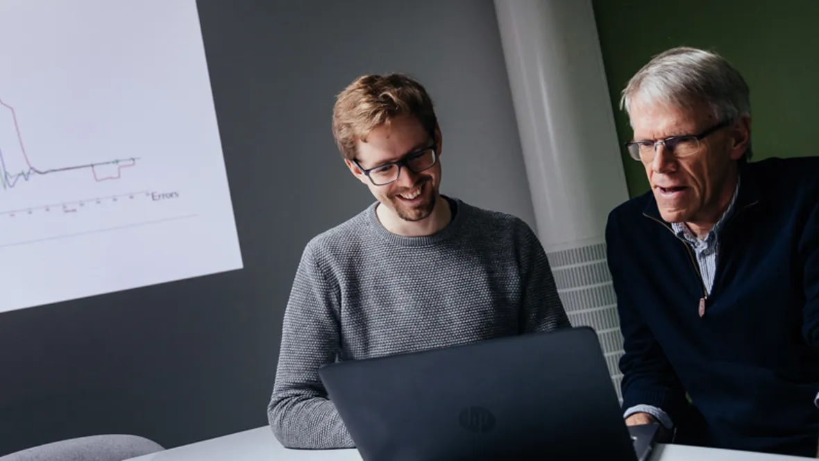 Researchers working at a computer.
