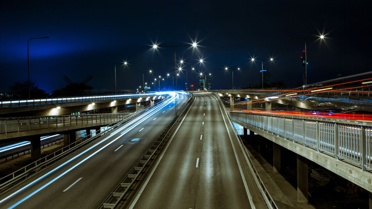 Urban environment at night with traffic.