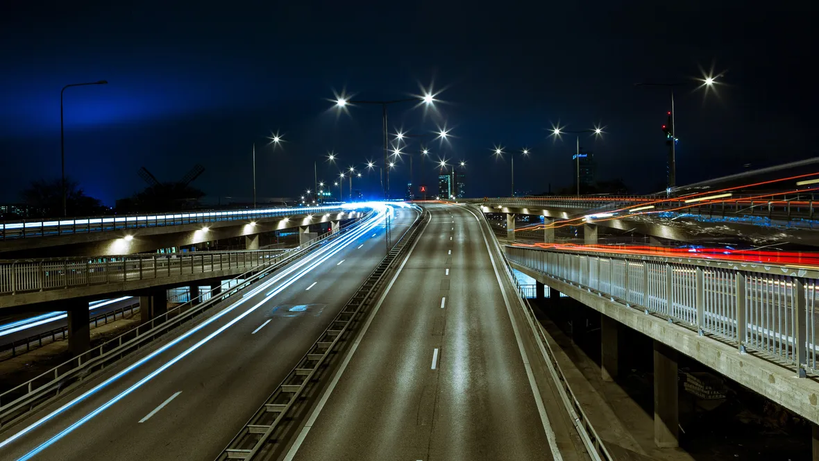 Urban environment at night with traffic.