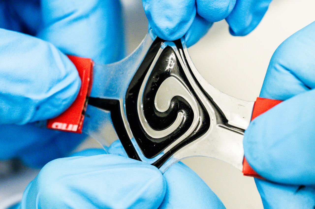 A flexible battery pulled in different directions.