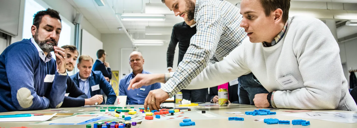 People have gathered around a table to solve a problem with construction logistics. 