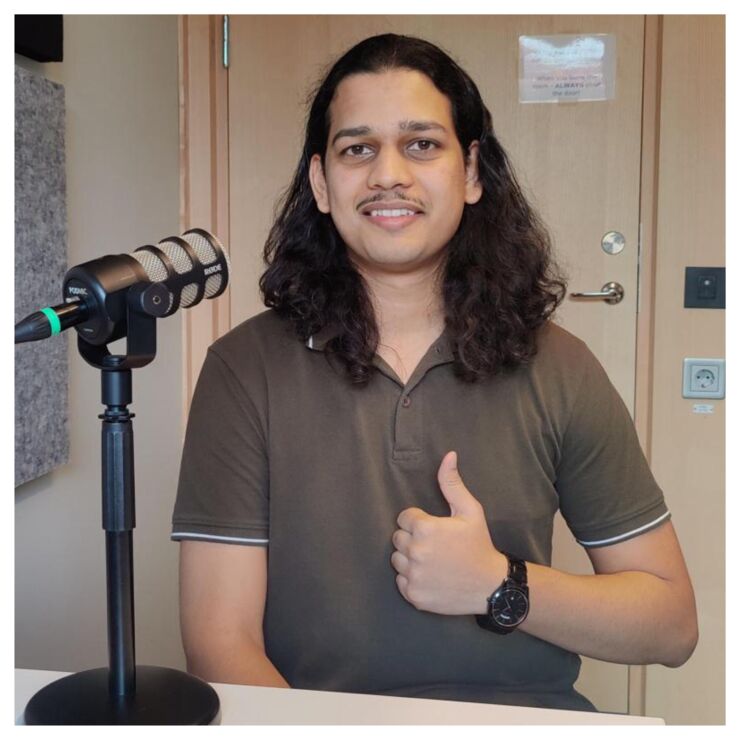 Episode guest Aditya Upadhyay is looking into the camera and doing a thumbs up.