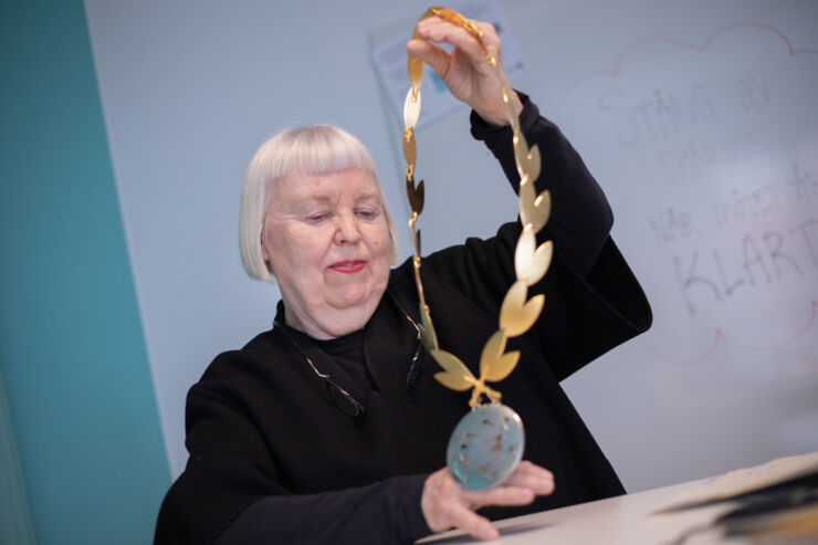 Kvinna håller upp en dekankedja