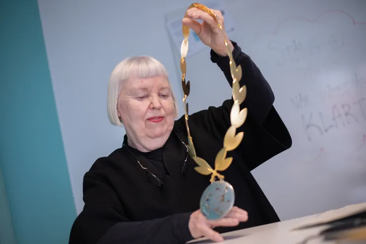 Kvinna håller upp en dekankedja