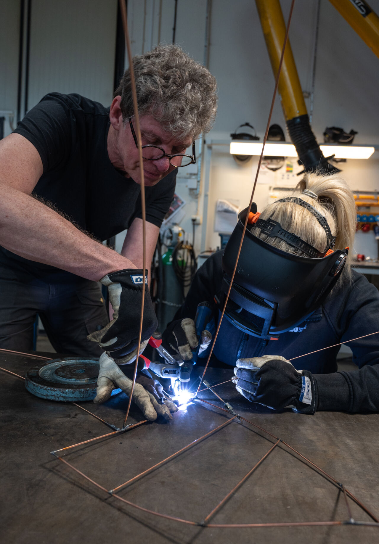 Mats Nåbo is working with the ceiling decorations together with Johanna Hagander.
