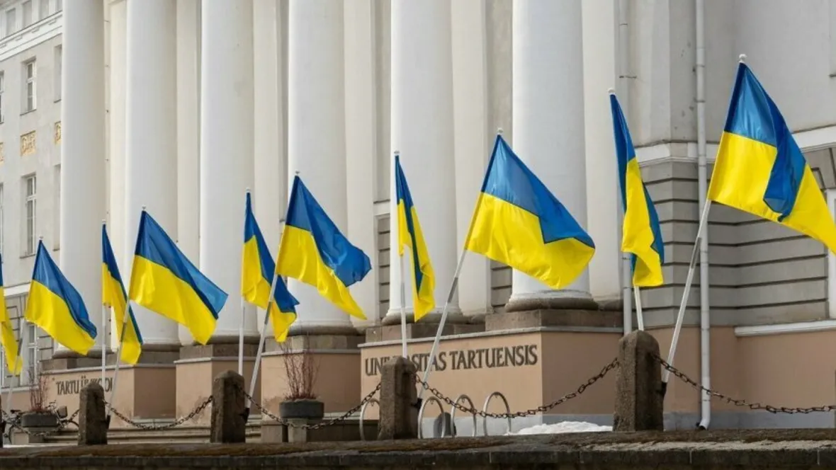 A building with Ukraine flags in front.