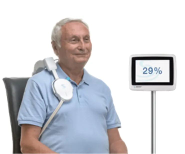 An elder man sitting in a chair and gets treatment