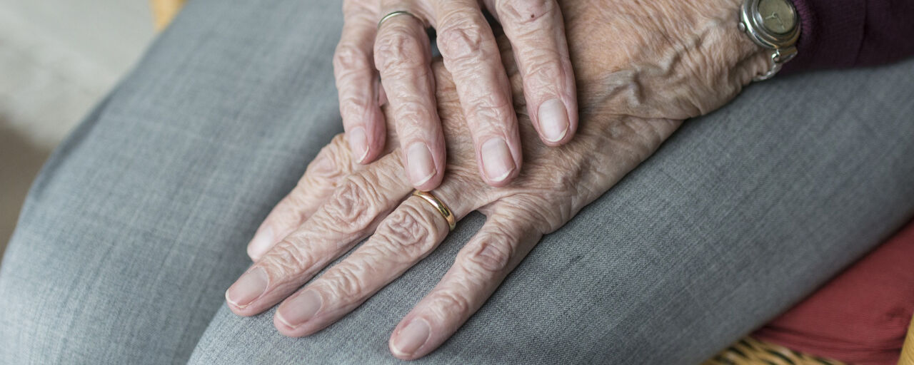 Två äldre händer som håller på varann