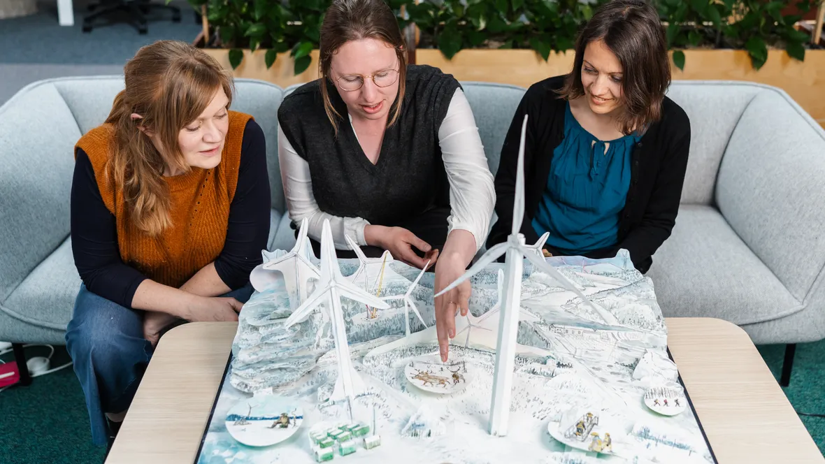 People looking in a large pop up-book