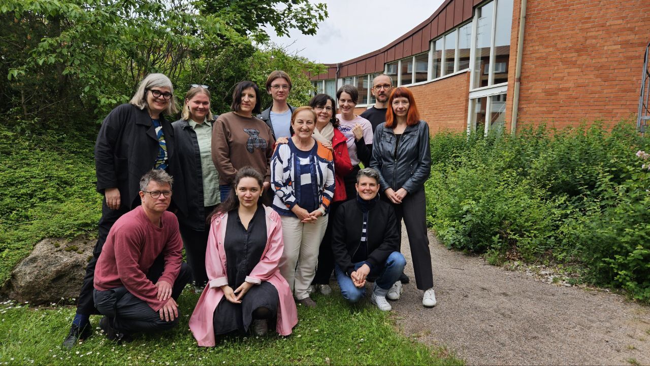 Group of people surrounded by greenery