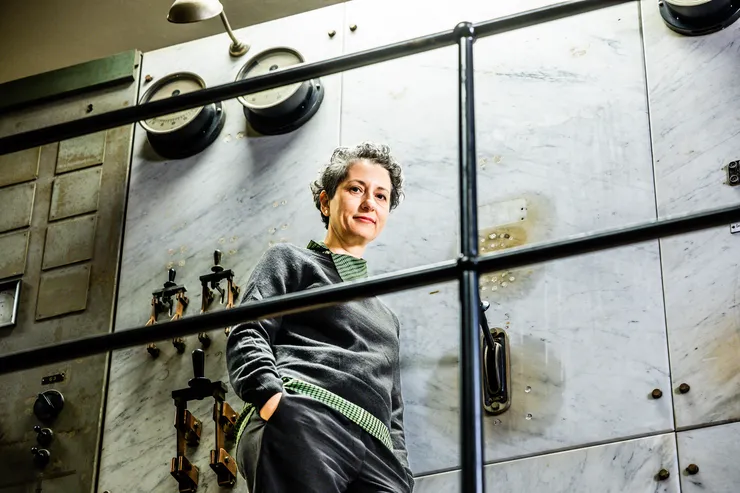 Theopisti Stylianou-Lambert, guest professor in the name of Moa Martinson, stands in a preserved old engine room in Kåkenhus – part of the industrial landscape in Norrköping.