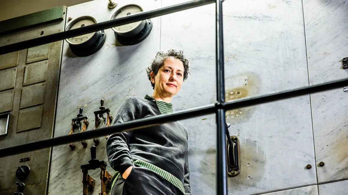 Theopisti Stylianou-Lambert, guest professor in the name of Moa Martinson, stands in a preserved old engine room in Kåkenhus – part of the industrial landscape in Norrköping.