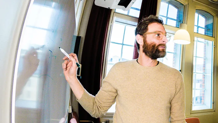 Man taking notes on whiteboard.
