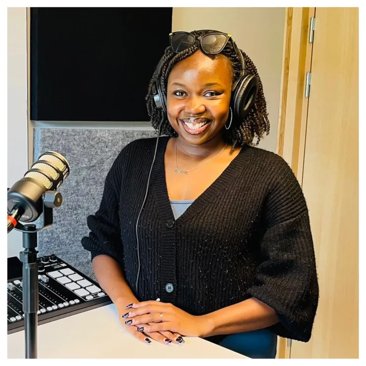 Episode guest Chelsea Draru Deborah is standing in the studio and smiling into the camera.