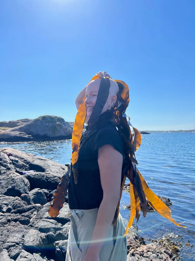 A person is holding algae on their head outside