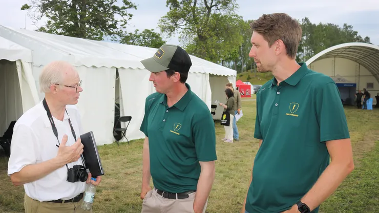 photo of three men discussing.