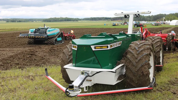 Bild på självkörande traktor och människor.