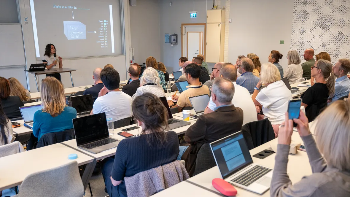 Föreläsare framför fullsatt sal