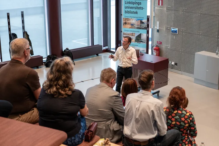 A man presenting to an audience, engaging the crowd with his speech and visual aids.