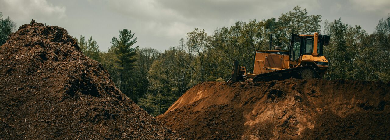 Dirt pile and backhoe