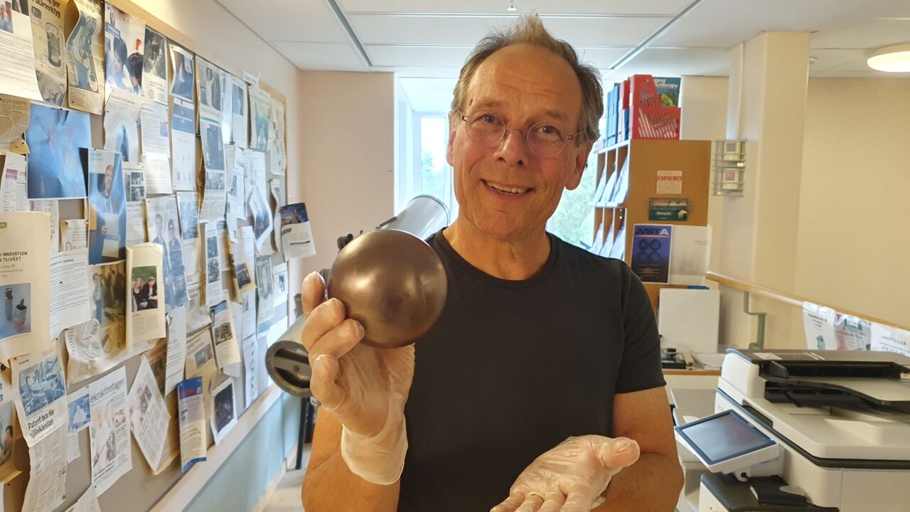 Researcher showing a probe to the camera