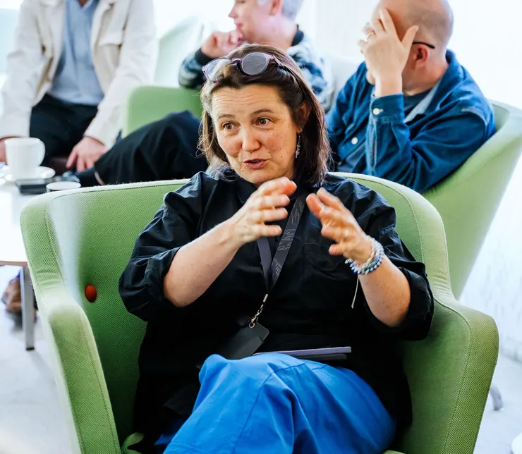 A woman is sitting in a chair indoors.