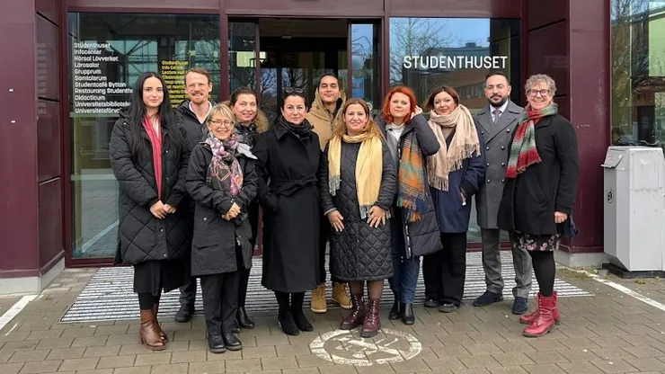 A ground standing in front of an entrance.