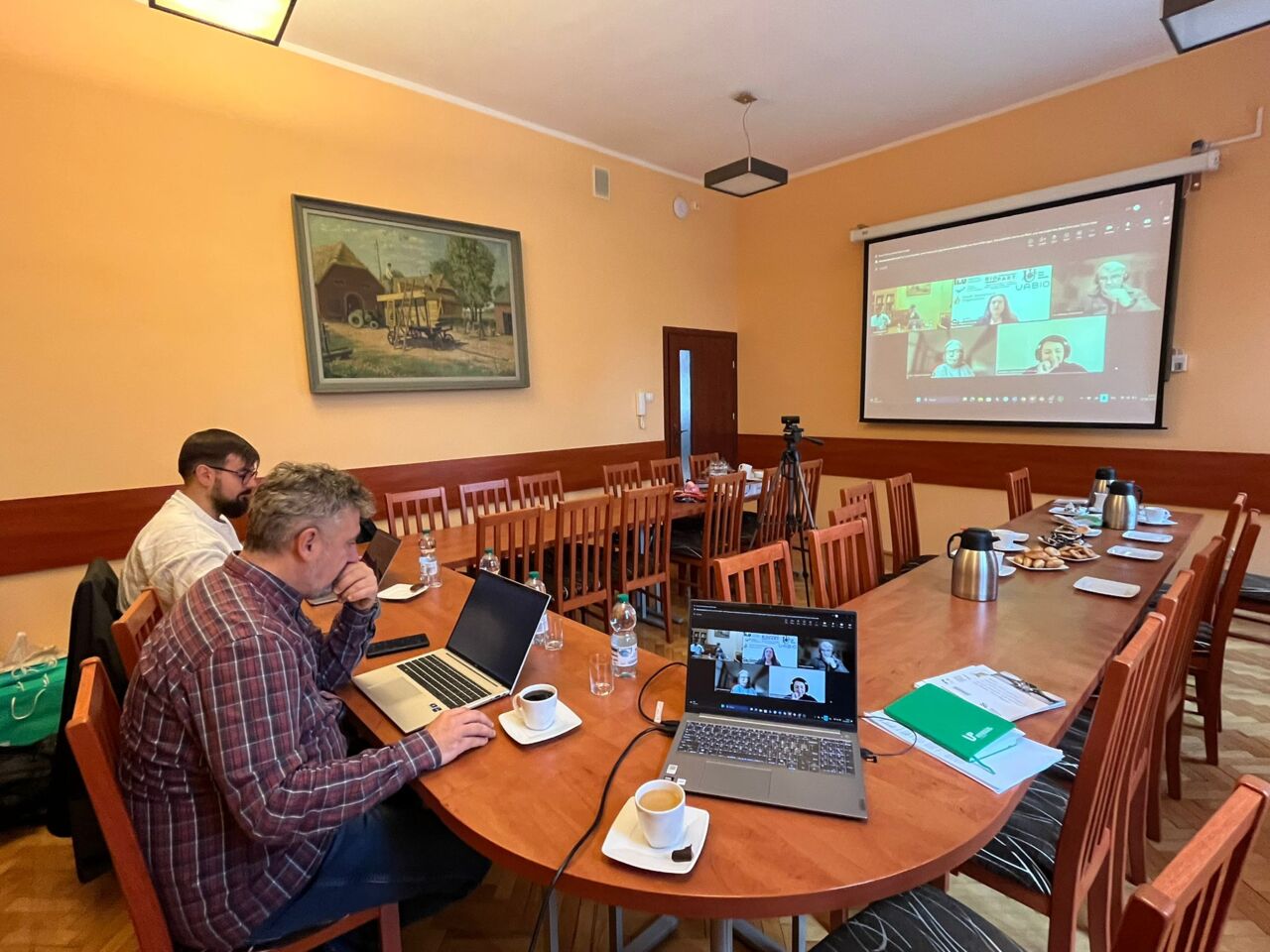 People sitting by a table having an online meeting