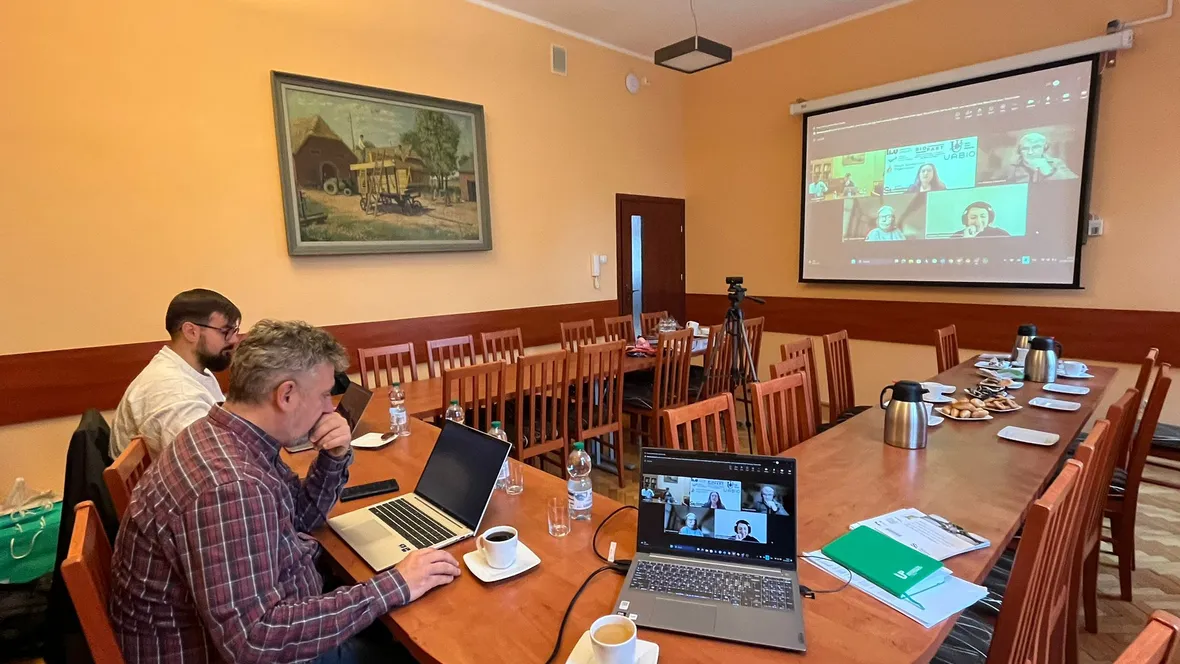 People sitting by a table having an online meeting