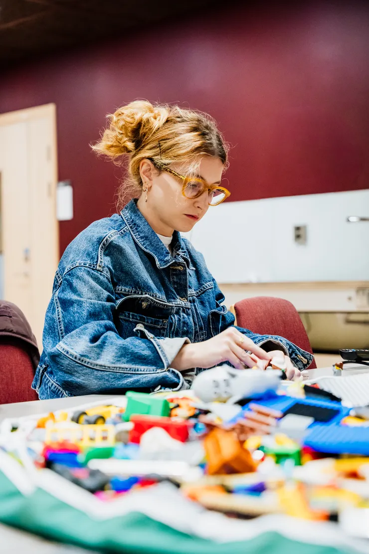Woman building with Lego.