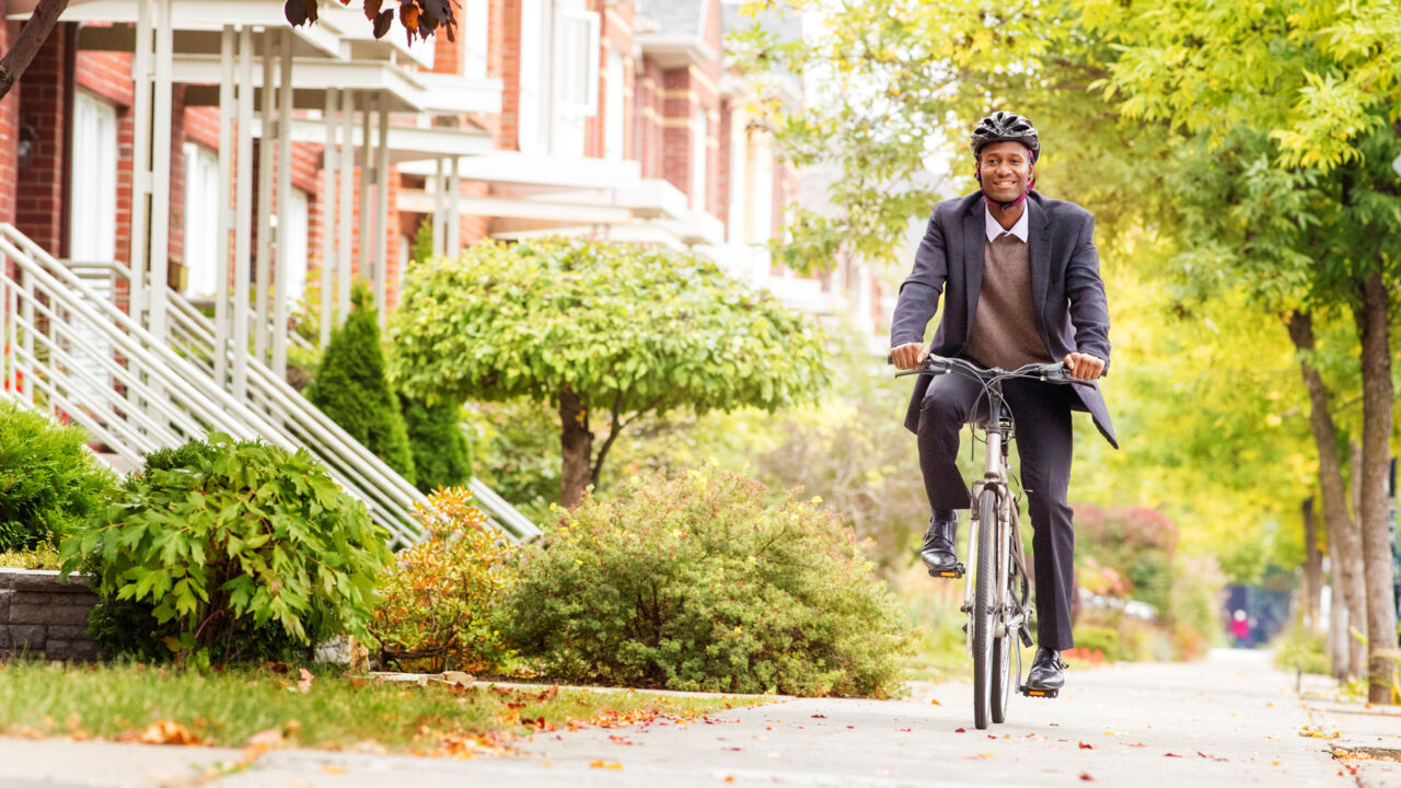 Man cycling on urban sidewalk