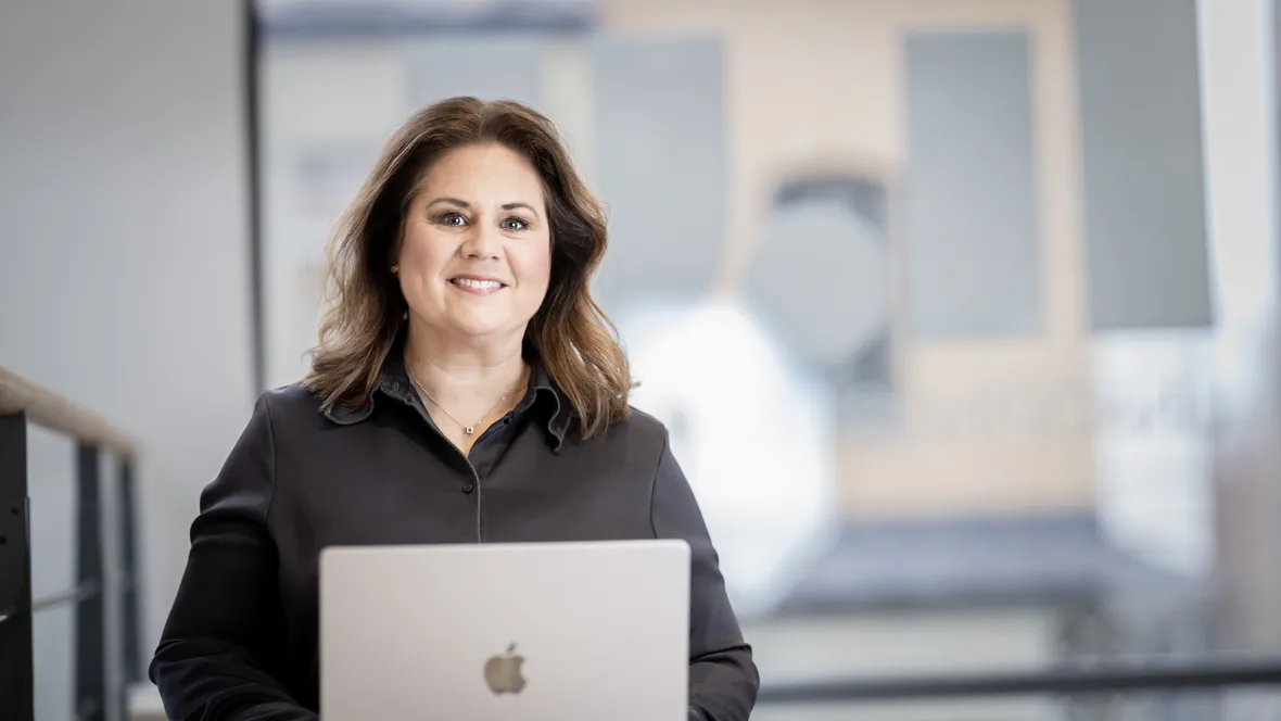 Woman looking up from working at her computer.