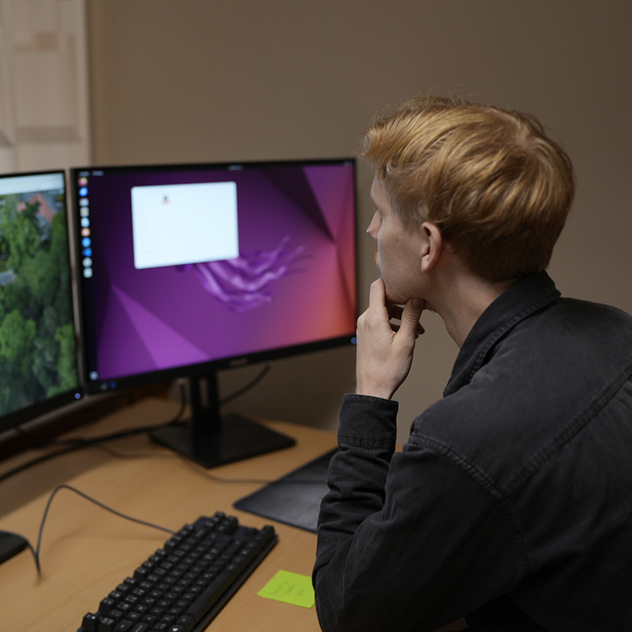 Student works in front of computer screens