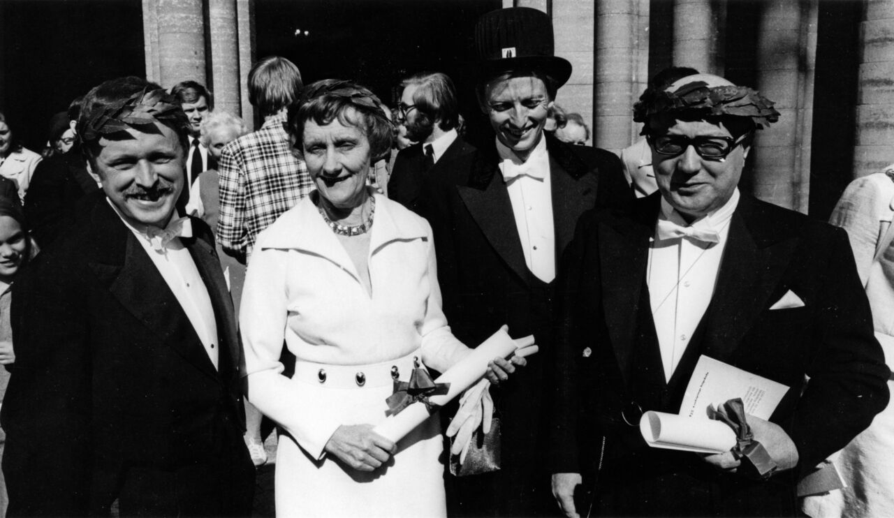 Several peoples are standing outside.