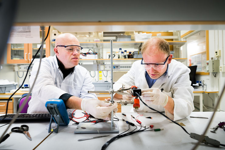 Två forskare monterar labutrustning