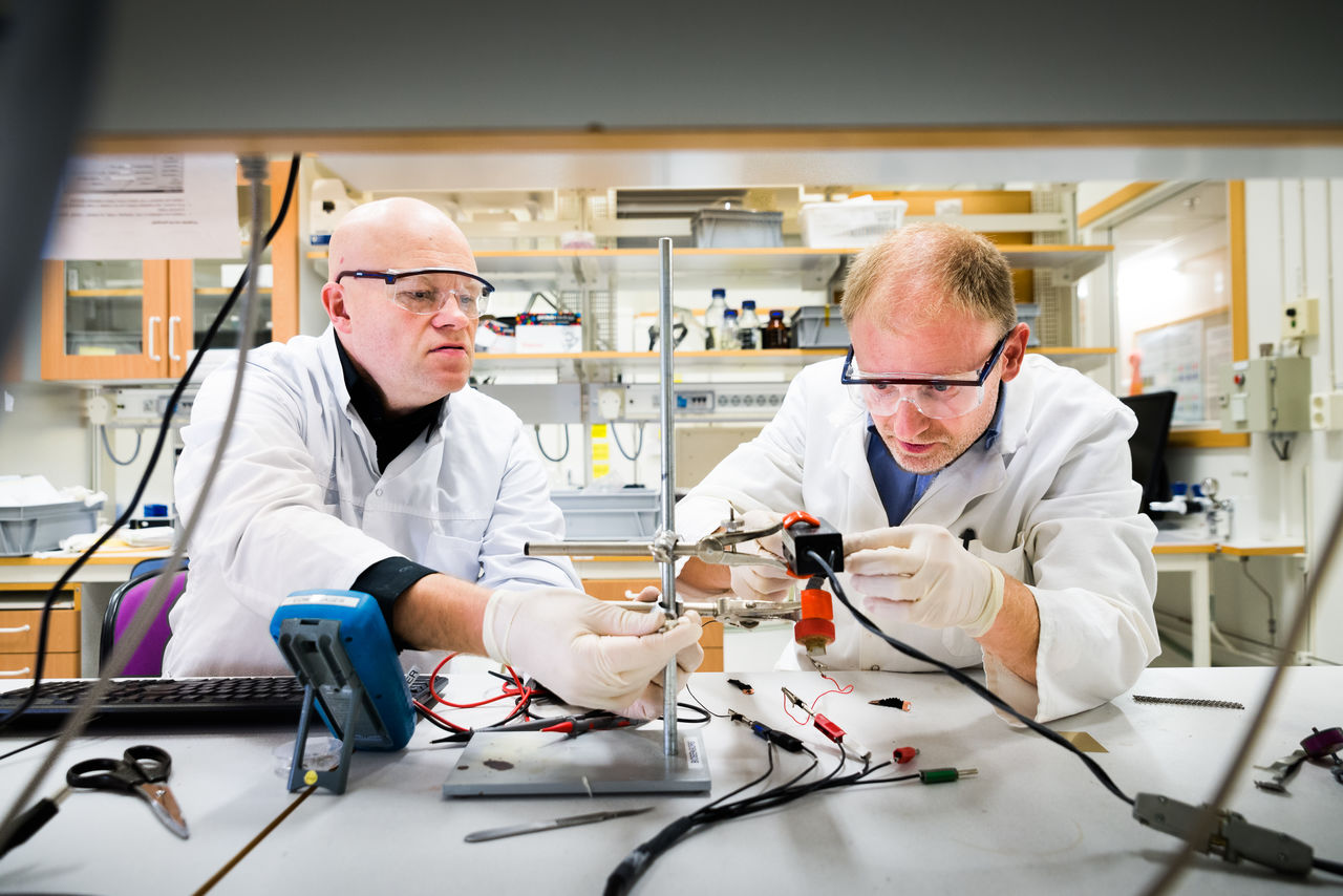Två forskare monterar labutrustning