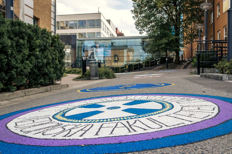 Foto på målade studentsektioners loggor på vägen upp mot entrén