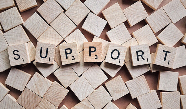 Scrabble bricks forming the word support.